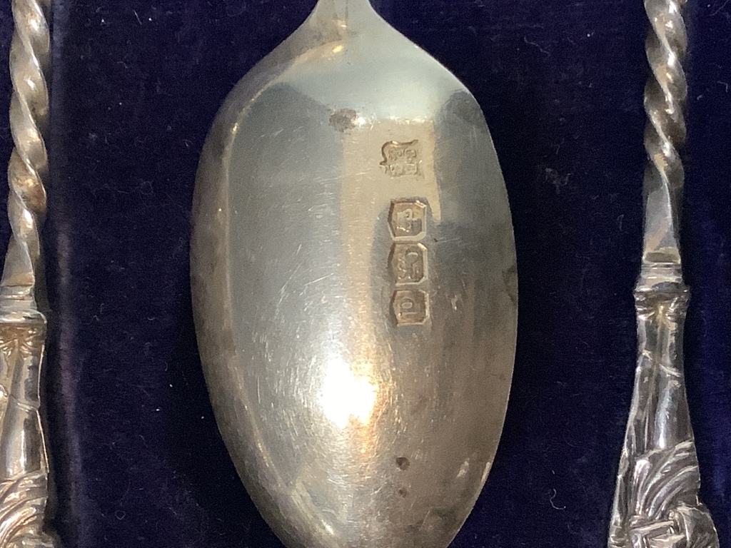 A cased set of six George V silver apostle teaspoons and a pair of sugar tongs, Cooper Brothers & Sons, Sheffield, 1921.